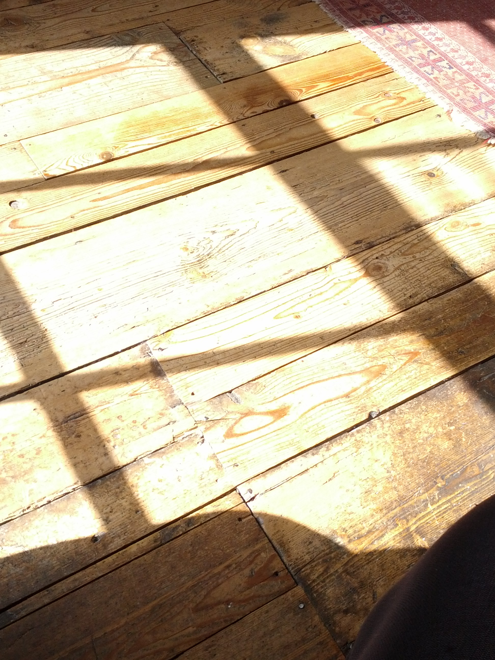 window=-cast shadows on wooden floor
